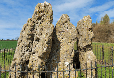 Great Rollright Stones by Embrace Historia. A close-up of three stones protected by an iron fence.